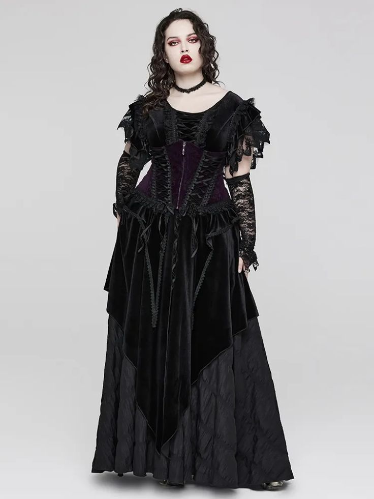 a fulllength studio shot of a model wearing a long gothicstyle black velvet dress. the dress features a fitted purple velvet corset bodice with black lace overlay, and a flowing black skirt with a layered design.  the model also wears black lace fingerless gloves and a black choker necklace. her dark hair is styled in loose waves, and her makeup enhances her dark and dramatic look. the overall style is gothic victorian or steampunk, with a combination of dark colors, lace, and luxurious fabrics. the background is a simple, neutral grey, allowing the dress and model to be the focus.