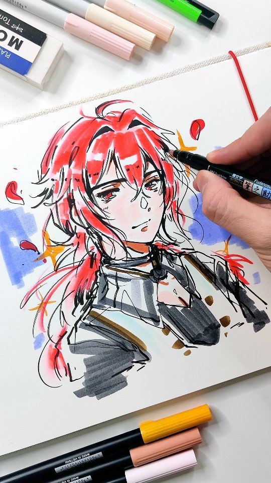the image shows a closeup view of an artist's hand drawing an animestyle male character with vibrant red hair. the character is sketched onto white paper in a sketchbook. the artist is using a black brush pen and copic markers of various colors. several other copic markers and a plastic eraser are visible on the table, suggesting the ongoing nature of the artwork. the style is dynamic and expressive, with visible brushstrokes and color blending.  the overall mood is one of creative work in progress.