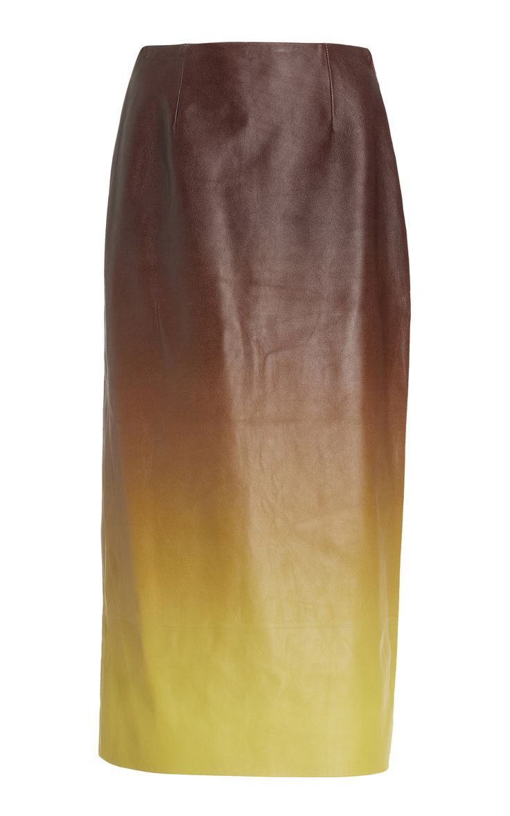 a brown leather skirt with a gradient to yellow. the skirt is high waisted and midi length.