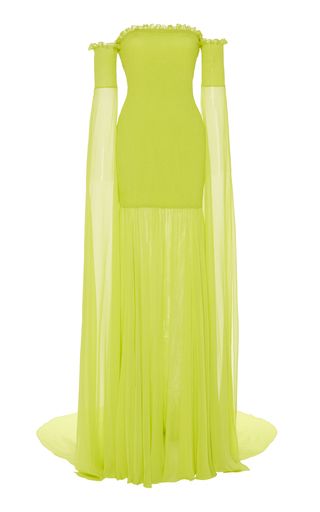 a neon green strapless gown with long sleeves is shown on a white background. the dress has a formfitting bodice and a long, flowing skirt. the sleeves are attached at the shoulders and extend to the floor.