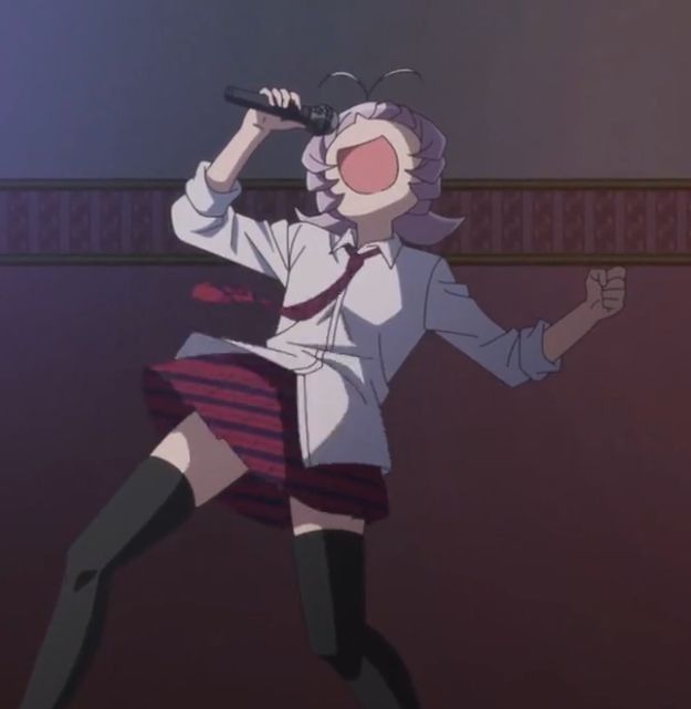 the image shows an anime girl with purple hair, wearing a school uniform consisting of a white shirt, red tie, and a pleated skirt, and black thighhigh socks. she is dynamically posed, singing into a microphone with her mouth wide open, and one arm raised in the air. the setting appears to be a karaoke room or similar venue.  the style is vibrant and expressive, typical of anime animation.