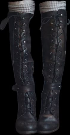 a pair of black highheeled boots with laces. they are made of leather and have a high shaft that goes up to the knee. the boots are laced up the front and have a pointed toe. they are a stylish and fashionable piece of footwear.