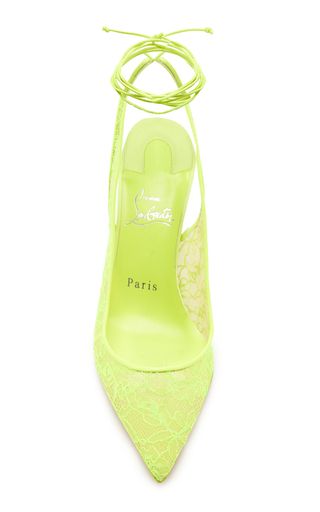 a pair of bright yellow stiletto heels by christian louboutin, featuring lace detailing. the shoes have a pointed toe and a slingback design. the brand's signature red sole is visible on the bottom of the shoe.
