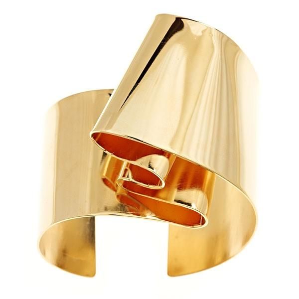 a gold bangle bracelet with a unique design. it is made of a single piece of metal that has been bent and folded to create a series of overlapping curves. the bracelet is shiny and smooth, and it is sure to make a statement.