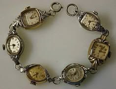 a vintage watch bracelet made of silver and gold with six watches on it. the watches have roman numerals and different colored hands.  this bracelet looks like a fashion statement and also a timekeeping device.