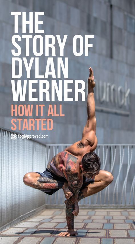 a muscular man with tattoos is doing a yoga pose in front of a gray wall with a metal railing. he is shirtless and wearing black shorts. he is balancing on one hand and is looking at the camera. the title "the story of dylan werner, how it all started" is written on the image.  the image is set outdoors in the city.