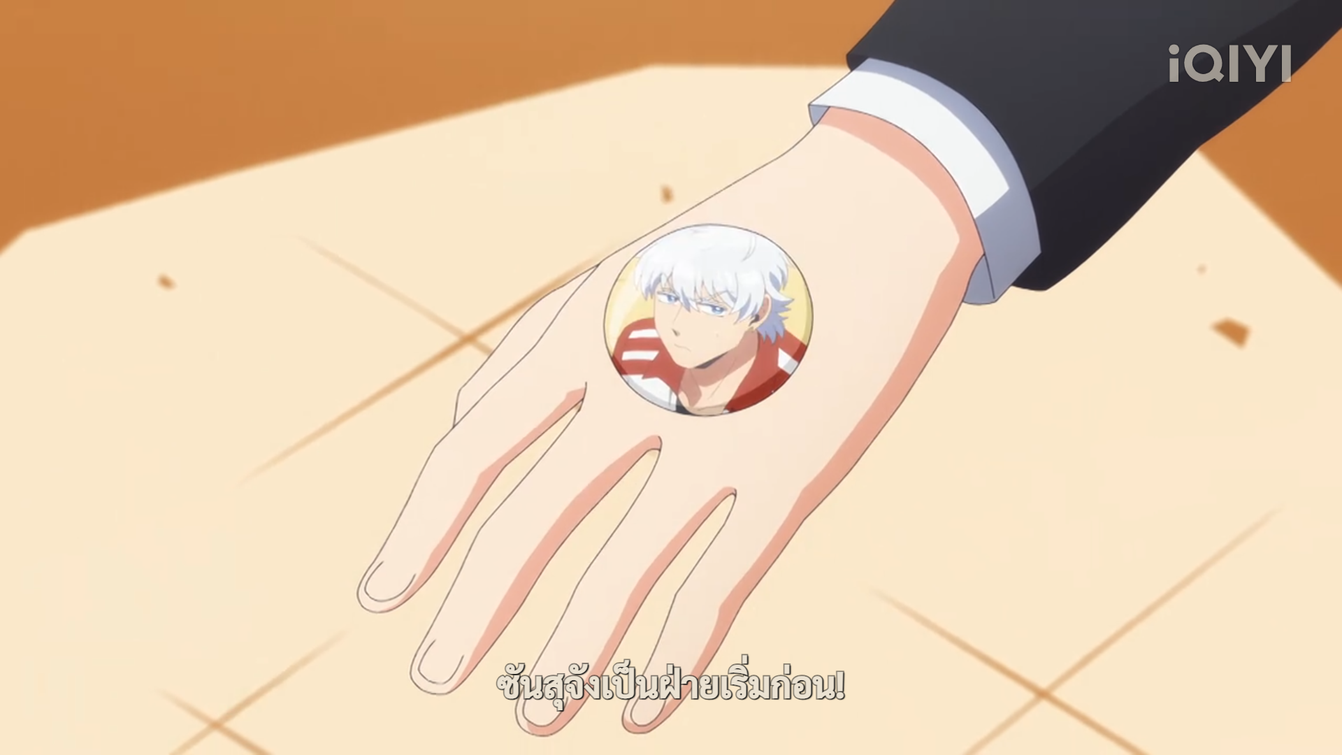 a cartoon image of a hand holding a pin with a picture of a man with white hair and a red shirt. the background is yelloworange.