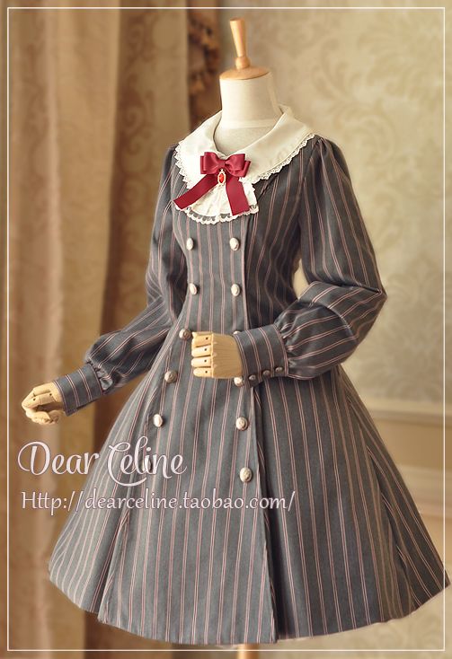 a fulllength image of a grey pinstriped lolita fashion dress on a mannequin. the dress features a white peter pan collar with lace trim, a burgundy bow, and a doublebreasted button closure. the dress has long sleeves with buttoned cuffs and a full, aline skirt.  the background is a creamcolored wall with a textured pattern. the lighting is bright and even, highlighting the details of the dress.