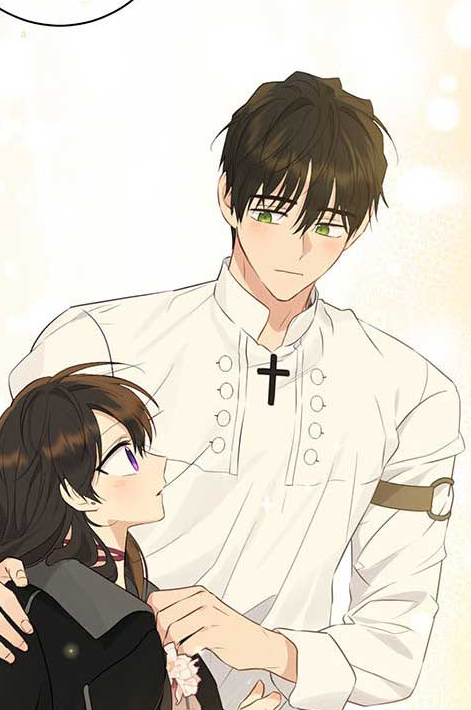 a man and a woman are shown in a close embrace. the man has his arm around the woman's shoulder and is looking down at her with a tender expression. the woman is looking up at the man with a shy smile. the man is taller than the woman and is wearing a white shirt with a cross on it. the woman is wearing a black dress. the background is a light color.