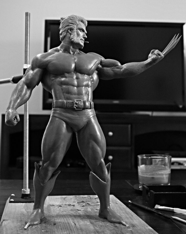 a grayscale image showcasing a meticulously sculpted statue of the iconic marvel superhero, wolverine. the statue captures wolverine in a dynamic pose, muscles tensed, his signature claws extended, ready for action. the detail in the sculpture is remarkable, highlighting the character's powerful physique and feral nature.  the setting appears to be an art studio, with tools of the trade scattered around the statue's base. the lighting is dramatic, emphasizing the statue's form and creating a sense of depth.