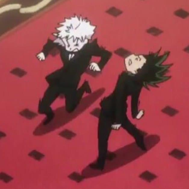 a digital fanart of killua zoldyck and gon freecs from hunter x hunter. killua and gon are dancing on a red carpet. killua is in the front and gon in the back. both are wearing a black suit. the image has a red background.