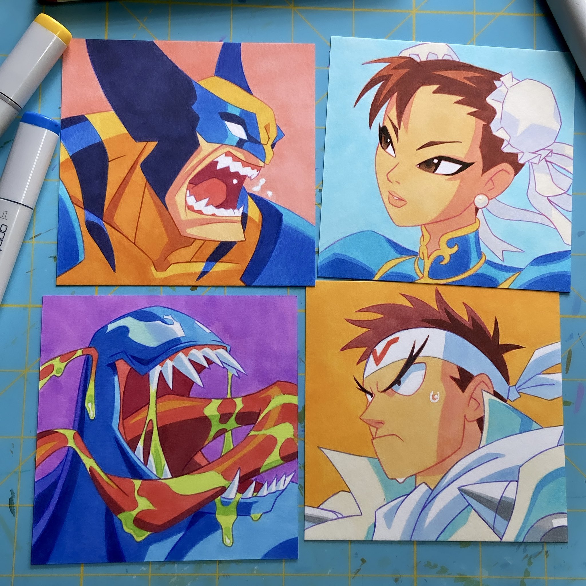 this is a collection of four handdrawn cartoon illustrations depicting wellknown characters from popular comic books and fighting games. the characters are, from top left to bottom right, wolverine, chunli, venom and ryu.  each illustration is on a square card with a brightly colored background and appears to be drawn with marker pens.
