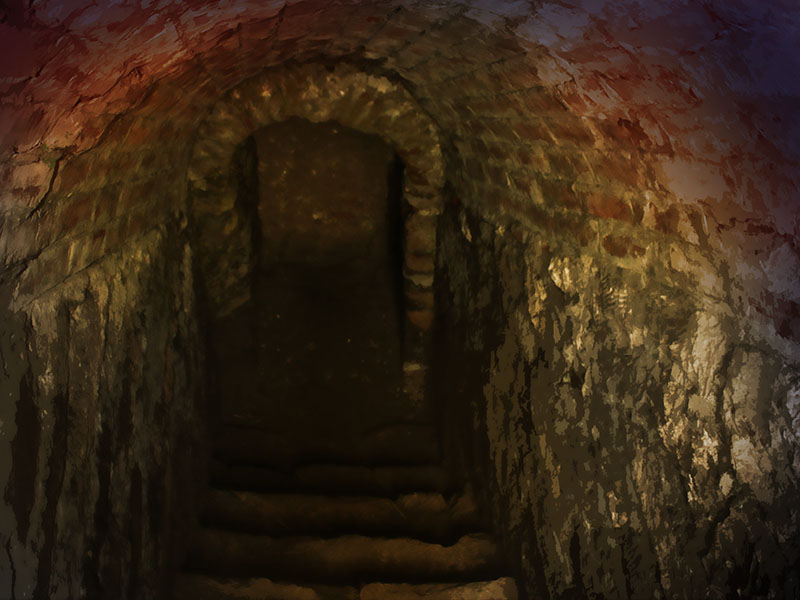 a dimly lit, bricklined tunnel with stone steps leading upwards through an archway. the structure appears old and underground.