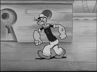 the image shows popeye the sailor man, a classic cartoon character, walking on the deck of a ship. he's drawn in his signature style with large forearms, a pipe in his mouth, and a sailor uniform. the style is that of early black and white animation.  the perspective gives a clear side view as popeye strides towards the right side of the frame.