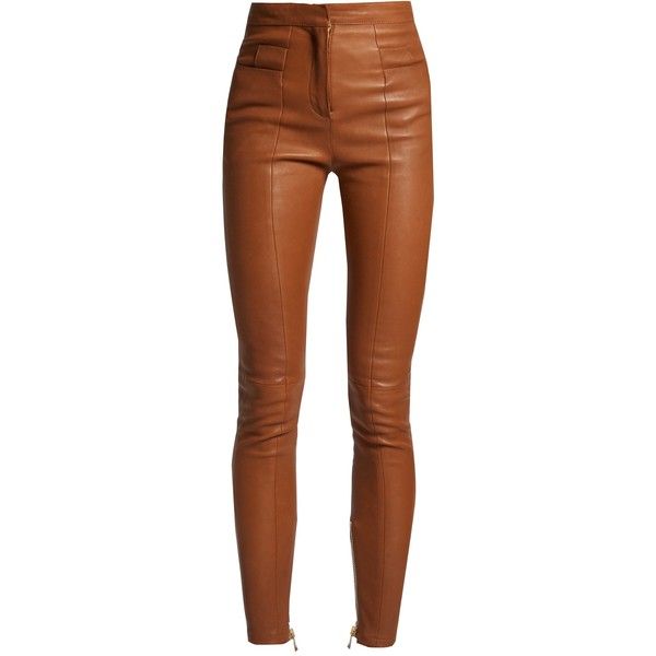 a pair of brown leather pants are shown in a studio shot. the pants are highwaisted and fitted, with a zipper detail at the bottom of each leg.