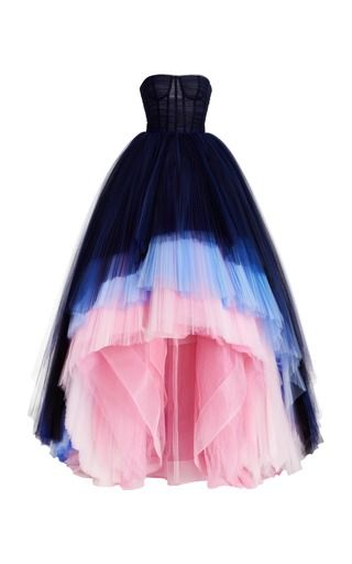 a strapless, highlow gown featuring an ombre effect with navy, blue, and pink tulle tiers. the dress has a fitted corset bodice and a flowing, tiered skirt.