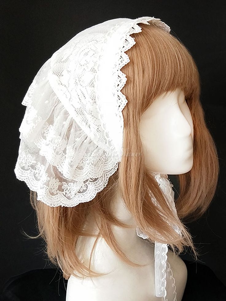 the image shows a white lace bonnet or cap worn on a mannequin head with light brown hair. the bonnet is made of delicate white lace with a scalloped edge.  it's styled to cover the ears and the back of the head, with a sheer, flowing design that drapes elegantly. the lace has a vintage or antique appearance, suggesting a romantic or classic style. the mannequin head provides a neutral background, allowing the detail of the lace bonnet to stand out as the central focus. the overall impression is one of delicate femininity and potentially a style associated with lolita fashion or victorianinspired aesthetics.