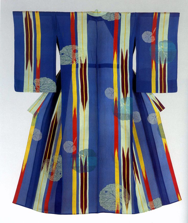 this image showcases a vibrant kimono with a predominantly blue color scheme. the garment is adorned with vertical stripes in various colors including red, yellow, maroon, and light green, creating a bold geometric pattern. interspersed throughout the design are depictions of leaves, adding an organic element to the overall composition. the kimono exemplifies traditional japanese fashion with its ornate and colorful design.