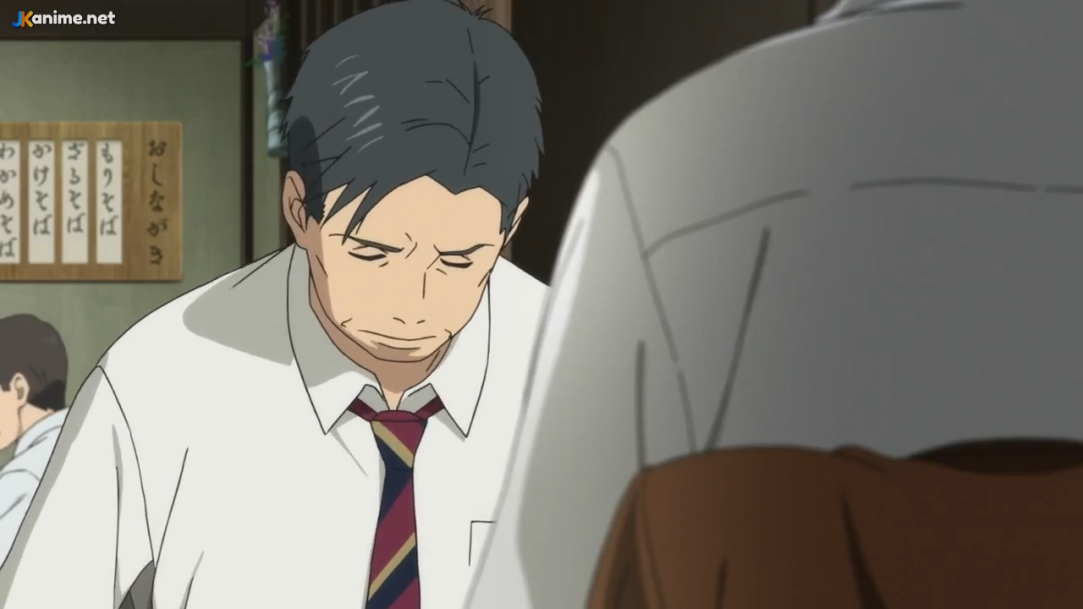 a closeup shot focuses on a man with short black hair and a solemn expression, wearing a white dress shirt and a striped tie. he appears to be looking down and slightly to the side, suggesting a sense of sadness or shame. the background features a blurred figure in a lightcolored shirt, indicating a conversation is taking place. the setting appears to be a restaurant or similar establishment, with warm, slightly dim lighting and wooden accents.