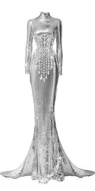 a silver sequined or paillettecovered, floorlength gown with long sleeves and a high neckline is displayed on a white background. the gown has a fitted bodice and a mermaid or fishtail skirt that flares out from the knees. the bodice has an embellished design with hanging details. the dress is elegant and glamorous and appears to be formal couture wear.