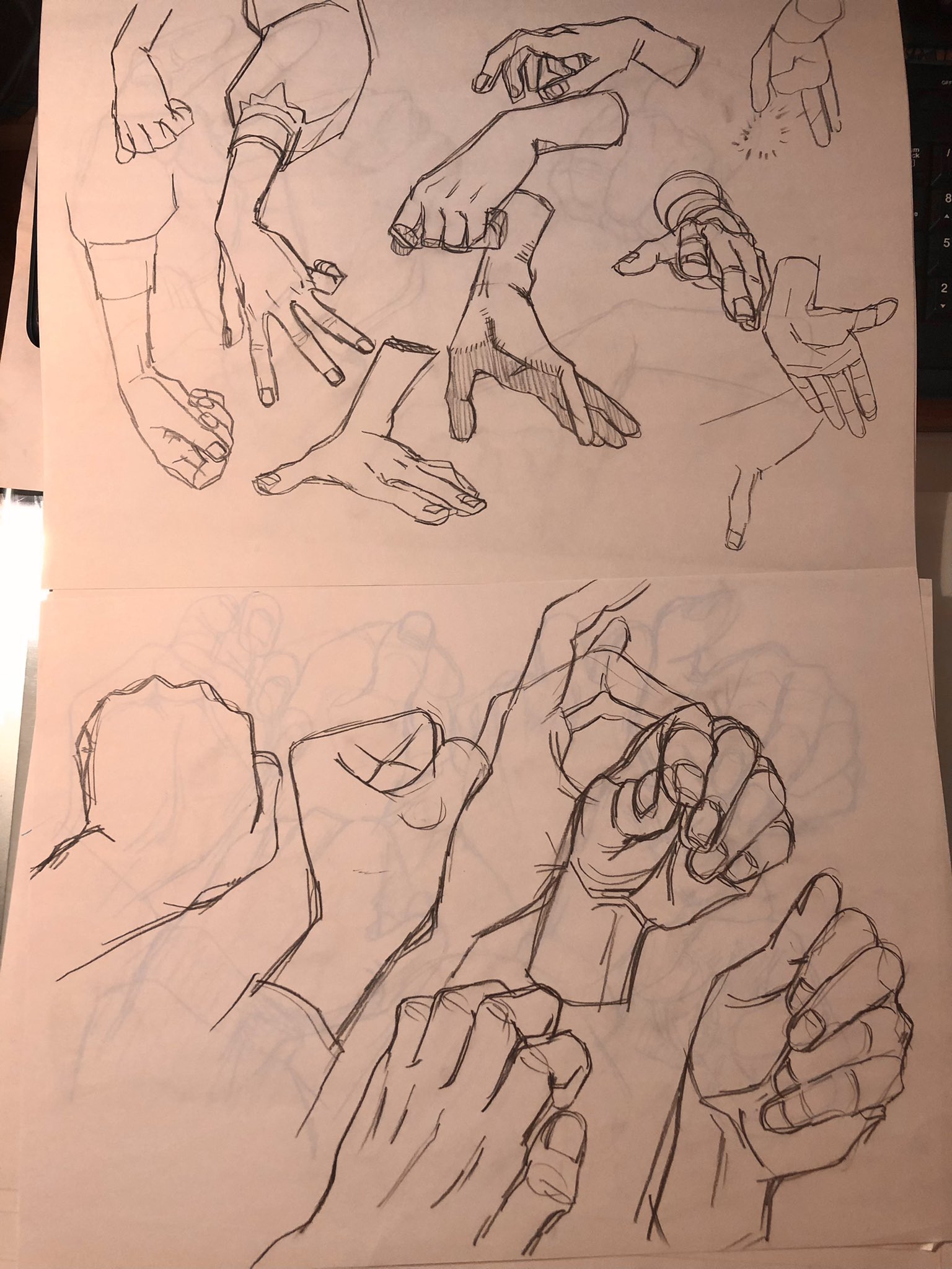 the image shows two pages from a sketchbook filled with anatomical sketches of hands in a variety of positions. the drawings are done in black ink on beige paper.