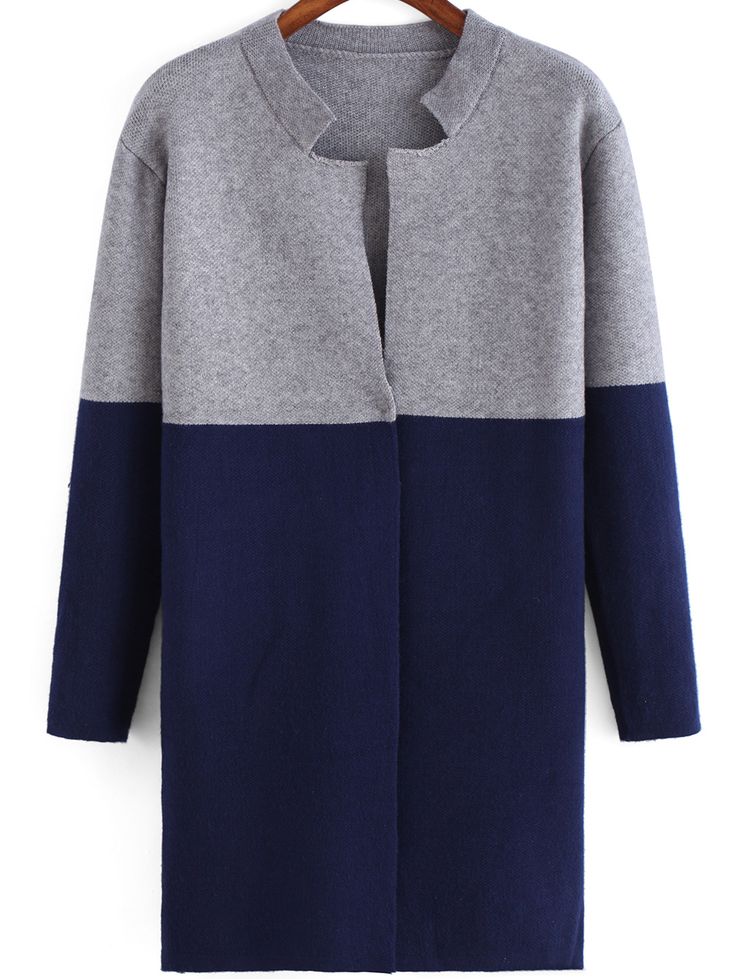 the image shows a long, colorblocked cardigan or sweater coat. the top portion is a light gray, while the bottom half, including the sleeves, is a navy blue. it has a collarless, openfront design.