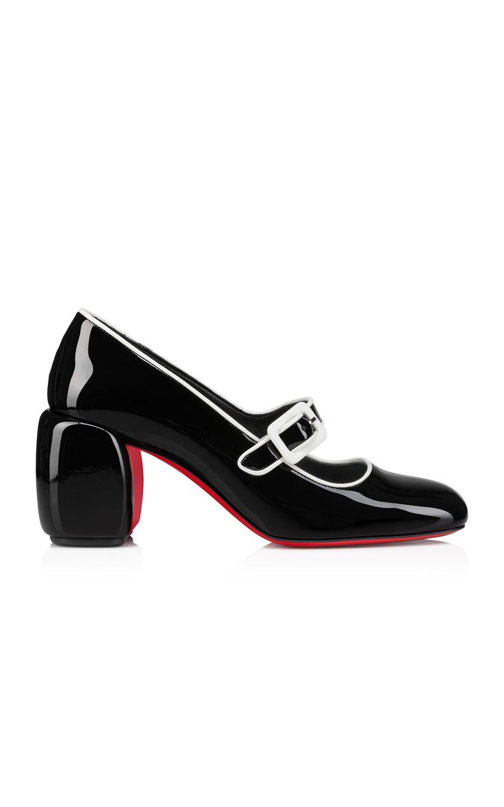 a pair of black patent leather pumps with red soles. the shoes have a chunky heel and a white strap across the top. they are styled on a white background.
