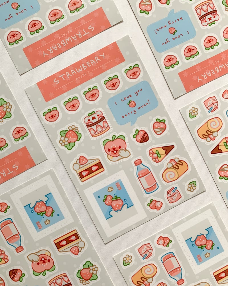 the image shows several sheets of cute, kawaiistyle stickers featuring strawberries, strawberrythemed desserts (like cakes and cream rolls), milk cartons, and drinks.  the stickers are in pastel pink and light grey tones, with a consistent aesthetic across all the sheets.  each sheet includes small repeating elements and phrases such as "i love you berry much!"  the style is appealing to those who enjoy cute and aesthetically pleasing stationery items.