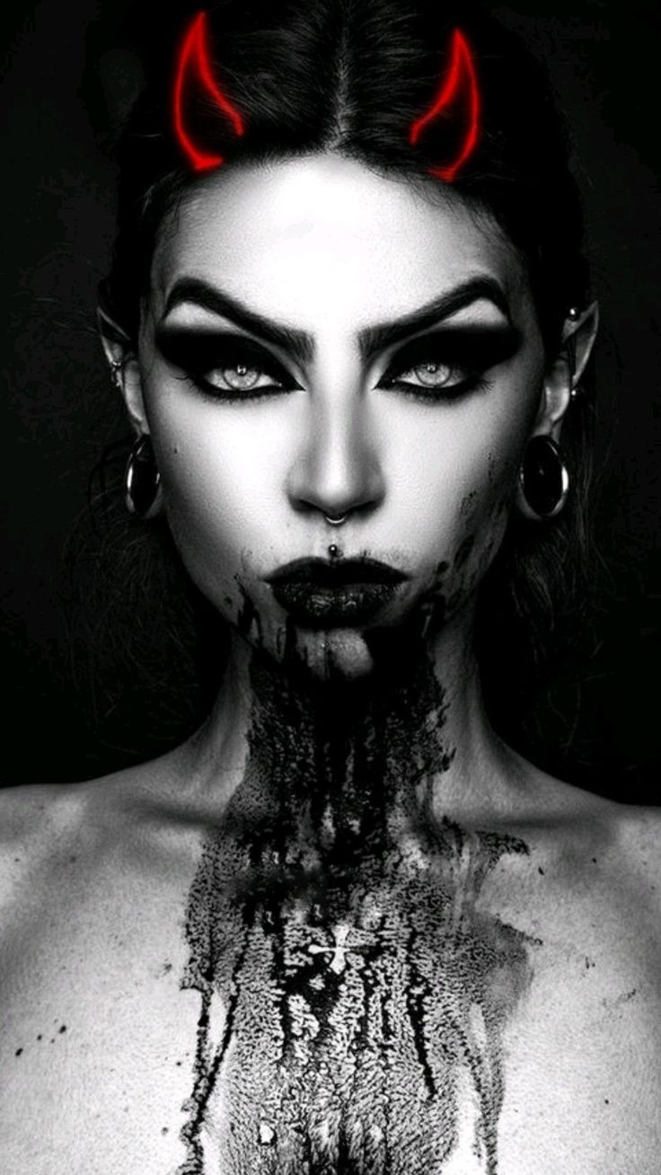 the image is a striking black and white portrait of a woman with a dark, gothic aesthetic. she has bright red devil horns superimposed on her head, heavy dark eye makeup, lip and septum piercings, and large gauge earrings.  dark, bloodlike substance drips down her chest. the overall style is intensely dark, seductive, and mysterious, hinting at a fantasy or demonic theme. the contrast between the black and white and the pop of red horns creates a dramatic effect. the woman's expression is intense and captivating.