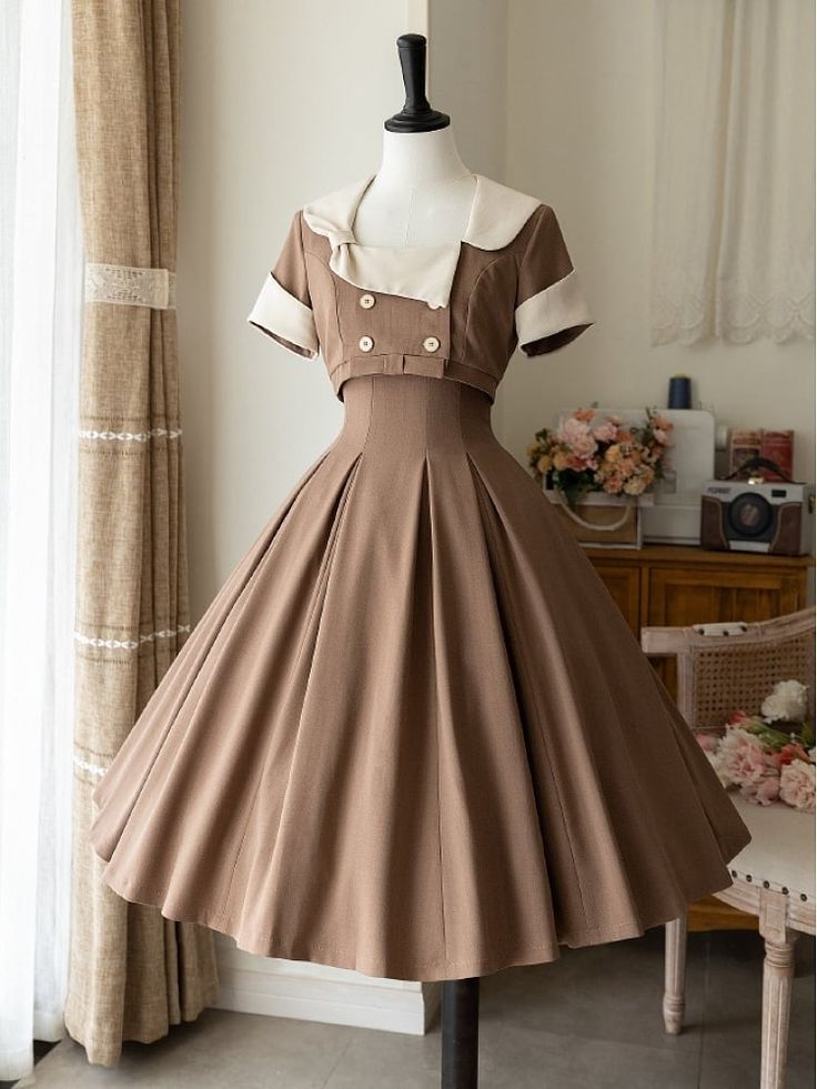 a vintageinspired brown dress with a full, aline skirt is displayed on a mannequin. the dress features a white collar and short sleeves, reminiscent of 1950s fashion. the image is taken indoors with soft, natural lighting, showcasing the dress's elegant and feminine silhouette.