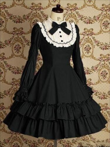 a black gothic lolita dress is shown against a patterned background.  the dress has a white lace collar with a black bow, long sleeves, and a full skirt with ruffles. the bodice of the dress is fitted and the skirt is full and flowing. the dress is made of a highquality fabric and is wellmade. the dress would be perfect for a special occasion, such as a party or a wedding.