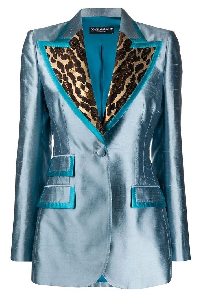 a women's singlebreasted blazer in a light blue color with an animal print design on the lapel. the blazer has a notch lapel with a turquoise trim, long sleeves, a flap pocket on each side, and a singlebutton closure. the interior lining is turquoise.