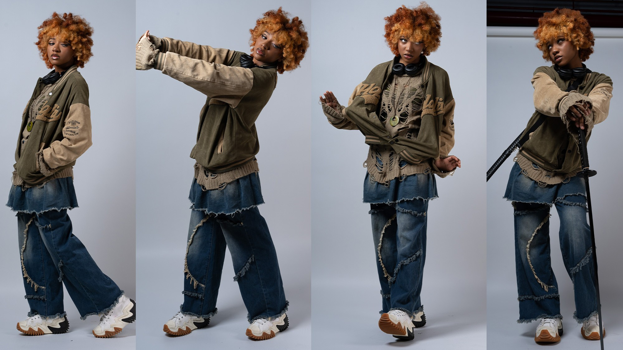 the image shows a young woman with bright orange curly hair modeling four different poses in a studio setting. she's wearing a layered outfit consisting of an oversized, distressed olive green and beige bomber jacket, a ripped beige sweater, a denim mini skirt layered over distressed denim wideleg pants, and sneakers. in one pose, she holds a katana.  the background is a plain grey, allowing the clothing and model to stand out. the overall style is streetwear with a grunge/alternative aesthetic.  the photos showcase the model's dynamic personality and the unique texture of the outfit.