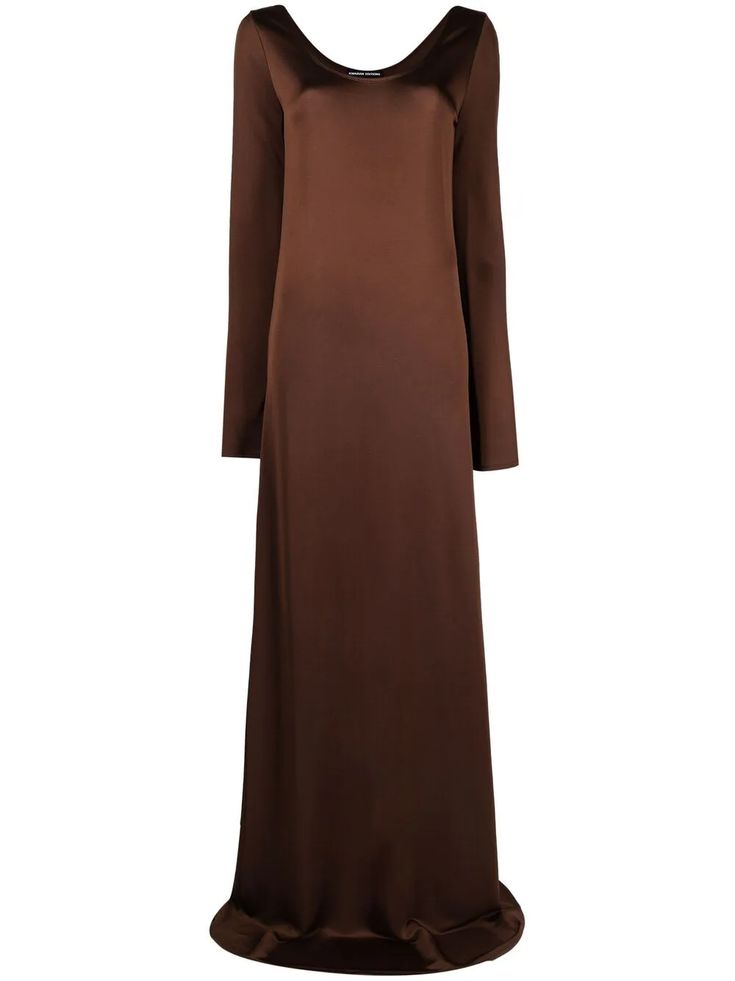 a fulllength studio shot features a longsleeved, brown maxi dress. the dress has a simple, elegant design with a modest neckline and smooth, flowing fabric.