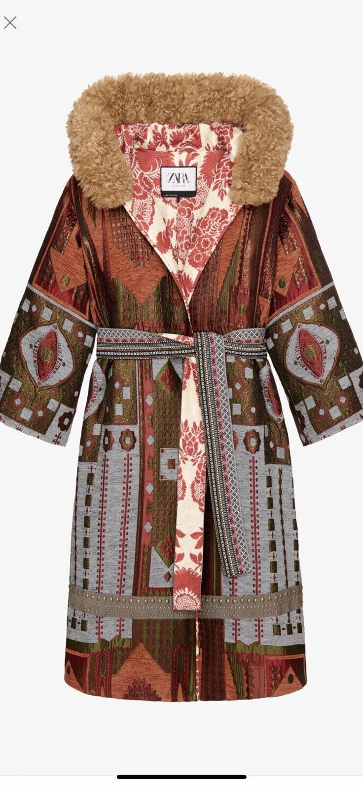 this is an image of a women's long coat. it is red, brown, gray and green with a floral and geometric pattern throughout. the coat has a faux fur collar and comes with a belt.