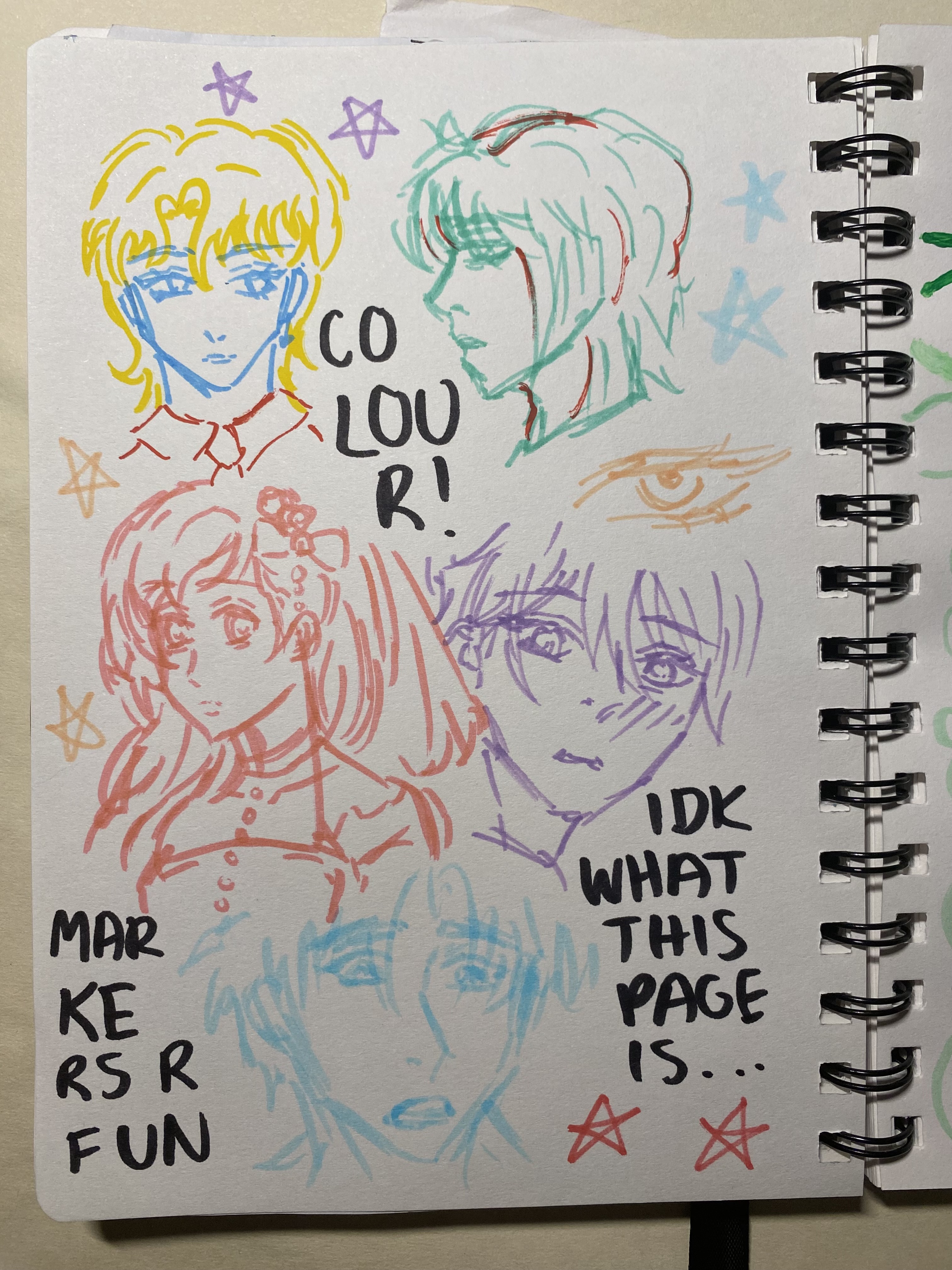 the image shows a page from a sketchbook filled with sketches of faces in an anime style. the sketches are done in different colors using markers. there are also scattered star drawings and handwritten notes that read "markers r fun", "colour!", and "idk what this page is...".