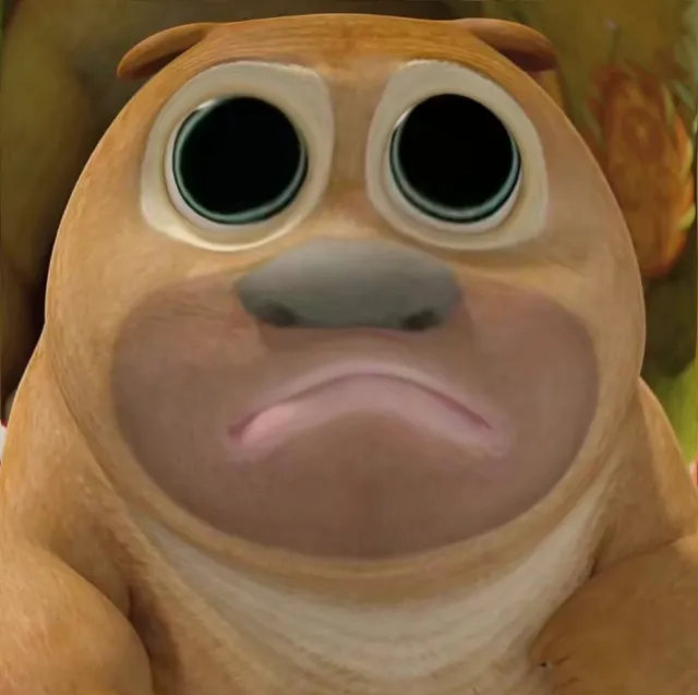 this is a closeup shot of a 3d animated, cartoon puppy with large, sad eyes. it is brown and white with a short snout and a downturned mouth. the background is blurry and out of focus, indicating a shallow depth of field. the lighting appears to be studio lighting, creating a clear and bright image.