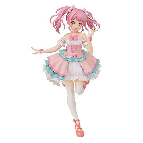 this is an anime figure of a girl with pink hair. she is wearing a pink and white dress with bows and ruffles. the figure is posed with one leg raised and one arm outstretched.  she has large pink eyes. the background is white.