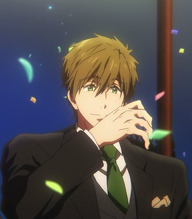 an anime character with green hair and green eyes is smiling and covering his mouth with his hand. he is wearing a suit and tie and there is confetti in the background.