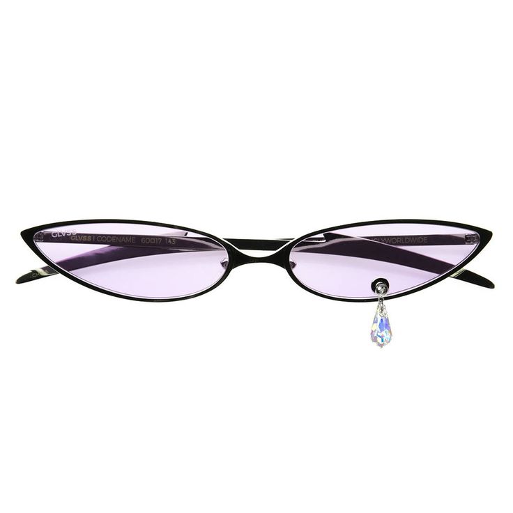the image shows a pair of black cateye sunglasses with light purple lenses.  a small, teardropshaped crystal charm is dangling from the right arm of the glasses. the sunglasses' arms are marked with text including "glvss" and "codename". the overall style is trendy and slightly edgy.