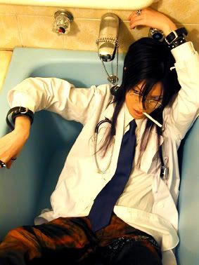 a woman in a white coat, a black tie, and black accessories, including a stethoscope is sitting in a bathtub and smoking a cigarette. her long, black hair is loose. she is looking to the side with a thoughtful expression on her face.