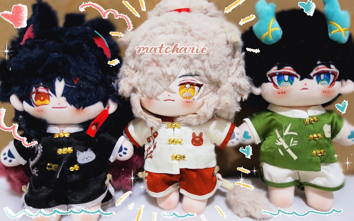 closeup of three adorable plush toys dressed in traditional chinese clothing. one is blackhaired with red eyes, one is whitehaired with yellow eyes, and the other has black hair with blue eyes. they all have cute faces and their clothes are decorated with intricate details.