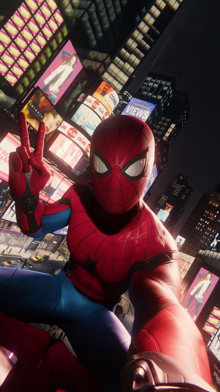 spiderman is taking a selfie in the middle of times square at night. he is standing in front of a lit up building with a billboard displaying "views." he is wearing his iconic red and blue suit and mask, and has his webshooters attached to his wrists. the cityscape is bustling with activity and the street is filled with cars and pedestrians. he is looking directly at the camera with a confident expression on his face.