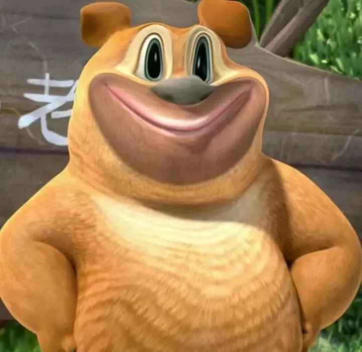 a cartoon bearlike creature with tan fur, wide eyes, and a large, toothy grin stands with its hands on its hips. the background suggests a forest setting. the character is rendered in 3d animation.
