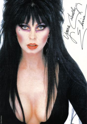 a portrait of a woman with long black hair and dark makeup. she is wearing a black dress with a plunging neckline and is looking at the camera. there is a signature in the top right corner of the image. the lighting is soft and creates a dramatic effect.