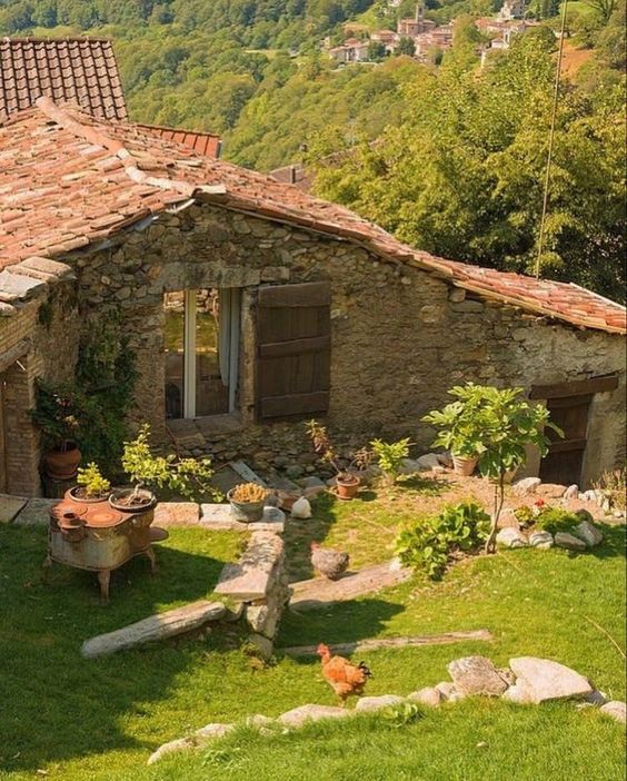 the image shows a charming stone farmhouse with a red tiled roof. the house is surrounded by a lush green garden, with a variety of plants and flowers. several chickens can be seen wandering in the yard. in the background, a small village nestled in the rolling hills is visible. the scene is bathed in warm sunlight, creating a peaceful and idyllic atmosphere.