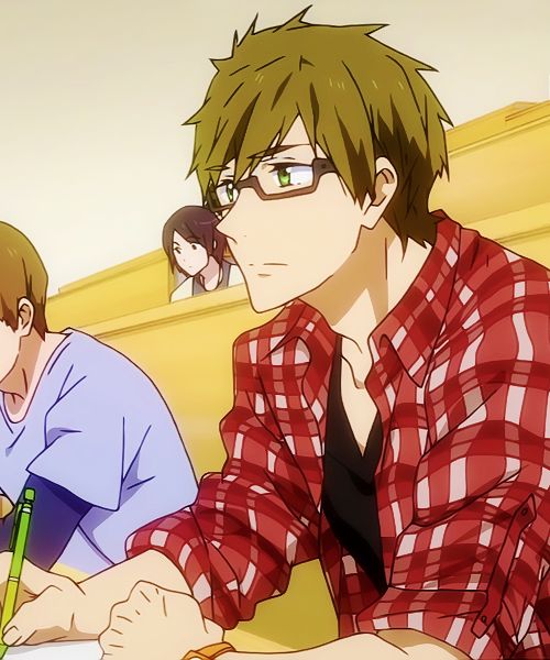 this image features a closeup of an anime boy with brown hair and green eyes. he is wearing glasses and a red and white plaid shirt over a black vneck. he sits in a classroom setting with other students behind him, looking slightly off to the side with a thoughtful expression. his posture suggests he might be studying or listening intently to a lecture.