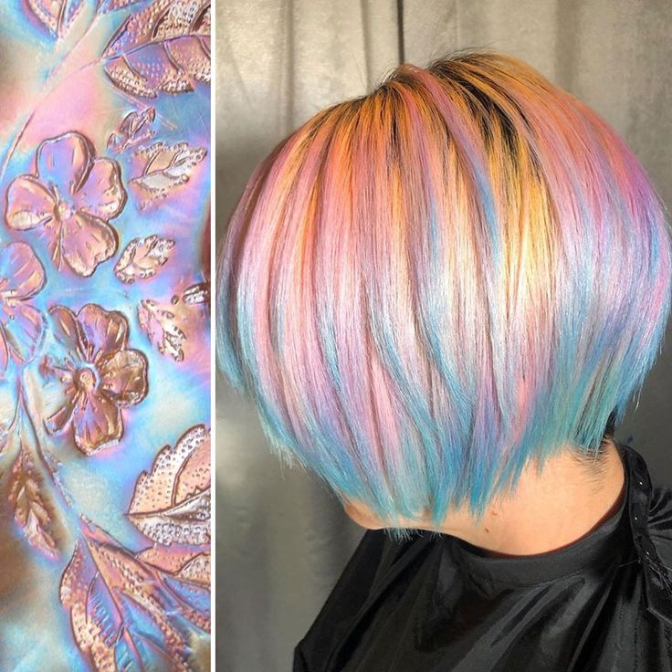 a woman with short, layered hair styled in a bob is shown with a vibrant rainbow color scheme, incorporating shades of pink, blue, yellow, and white into the overall look. the hair is styled in a way that creates a color blocking effect, with the colors blending into one another to create a multidimensional effect. the hair is styled with a slight wave, adding to the overall texture and visual appeal of the hairstyle. the woman is wearing a black cape, which helps to accentuate the vibrant colors of her hair. the lighting in the image is soft and diffused, creating a flattering and luminous effect on the hair.