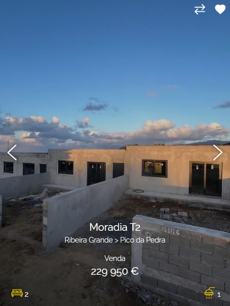 a wide shot of a new modern home for sale. the home is made of brick and stone and has a modern exterior. the home has a large front yard, a patio, and a driveway. the home is located in a sunny location and has a view of the sky and clouds. the photo is taken from a low angle, giving the viewer a good view of the entire front of the house.