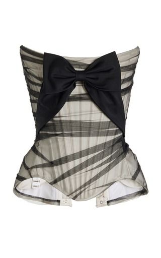 the image shows a striped strapless corset top with a black bow in the center. the top has black and cream stripes and a corsetlike design. the bow is large and made of black fabric. the top is shown against a white background.